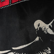 Black t-shirt with a white bird graphic and red and white text at the top.