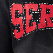 Black sweatshirt with red 'SER' text and rhinestone embellishments.
