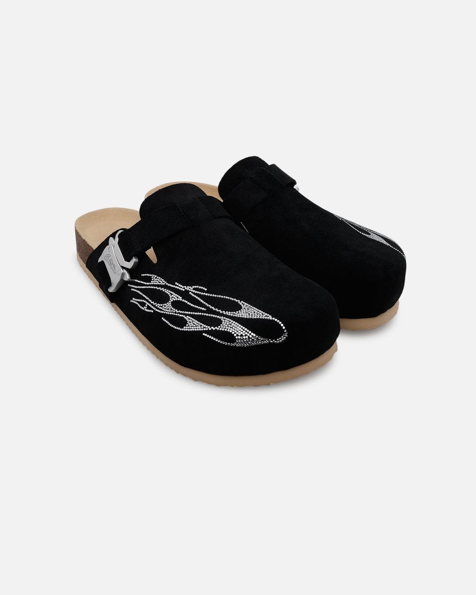 Pair of black clogs with decorative elements on a white background