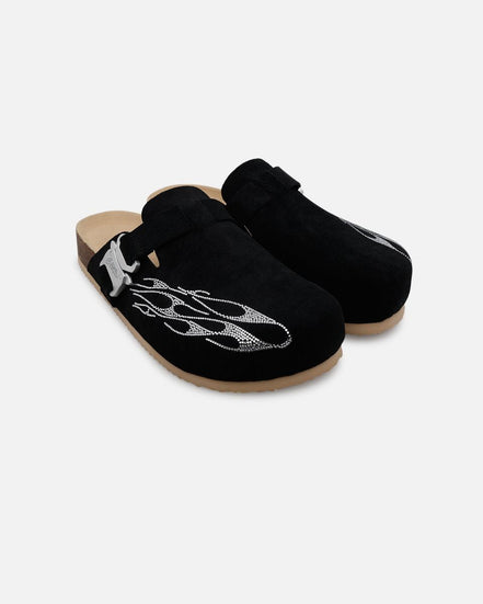 Pair of black clogs with decorative elements on a white background
