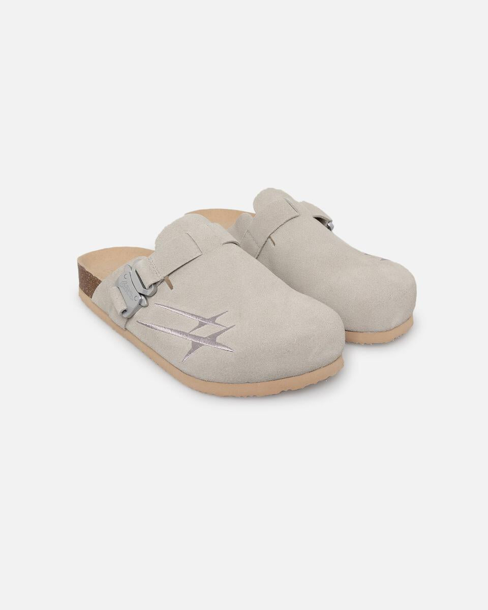 Pair of beige clogs on a white background