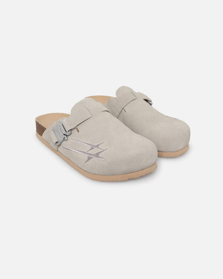 Pair of beige clogs on a white background