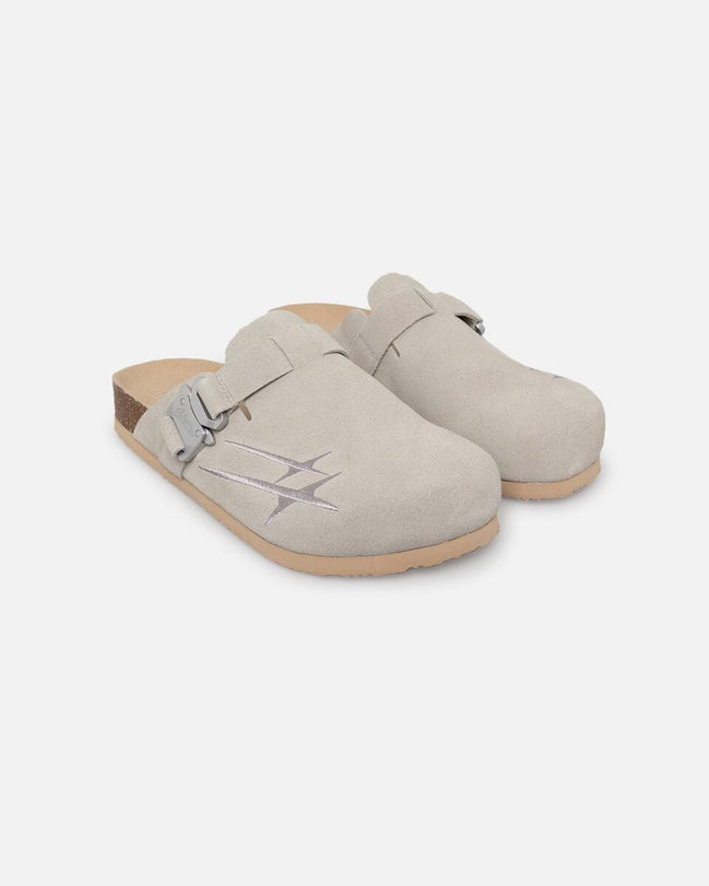 Pair of beige clogs on a white background