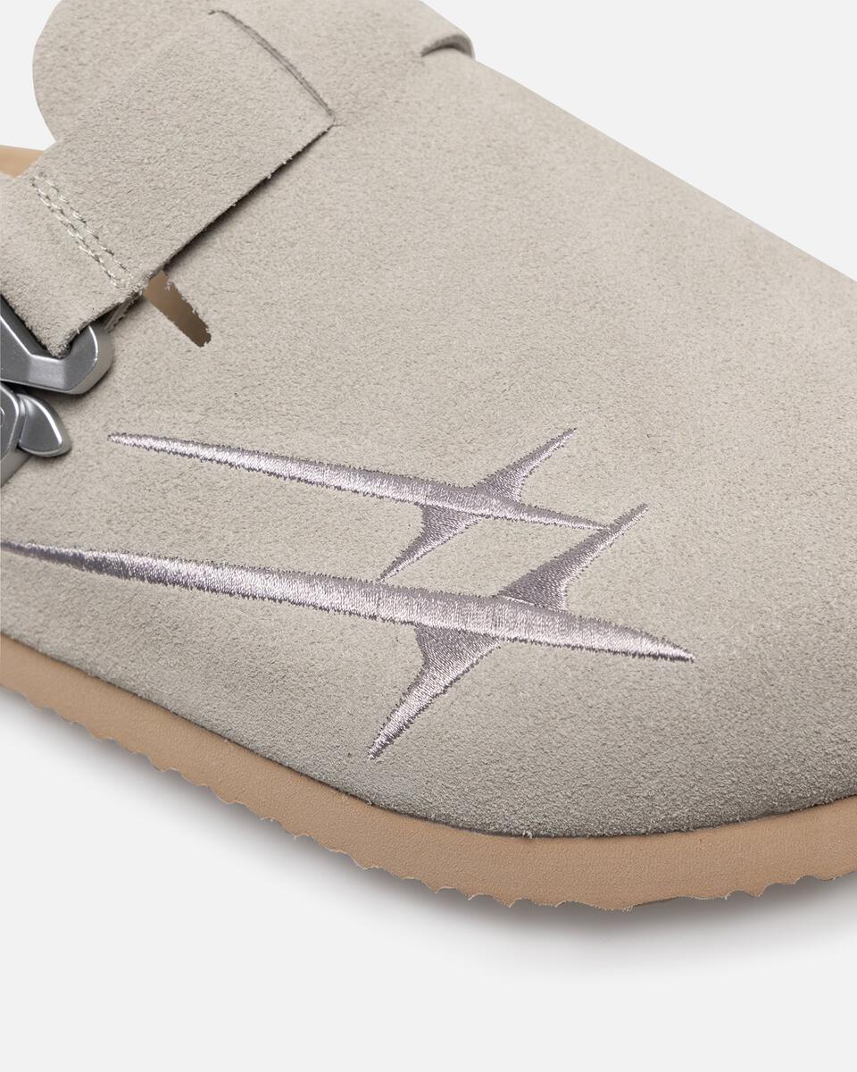 Close-up of a light gray slipper with a star design on a white background