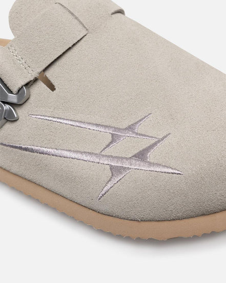 Close-up of a light gray slipper with a star design on a white background