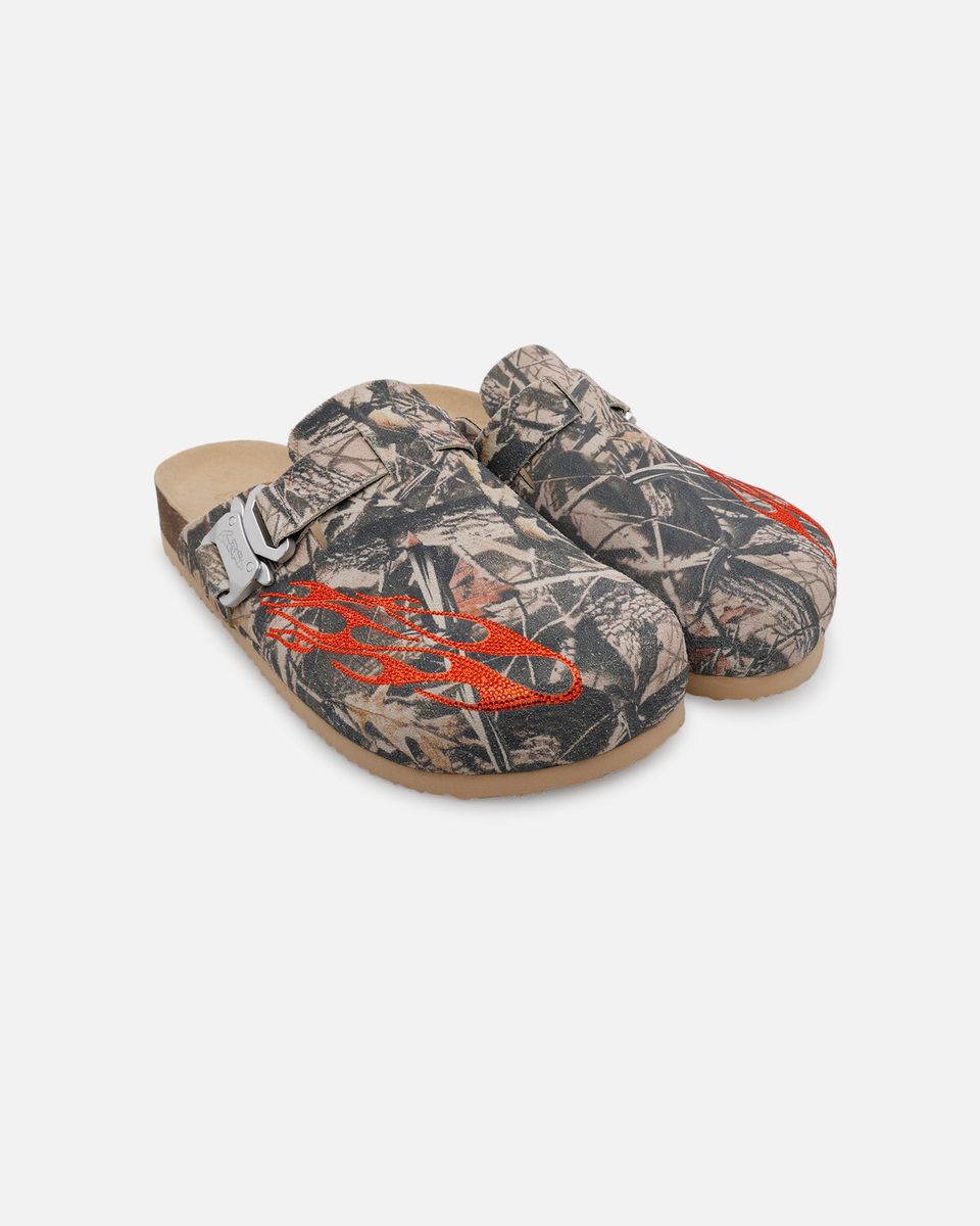 Pair of camouflage-patterned clogs with orange accents on a white background