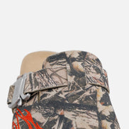 Camouflage-patterned belt with red accents on a mannequin against a white background