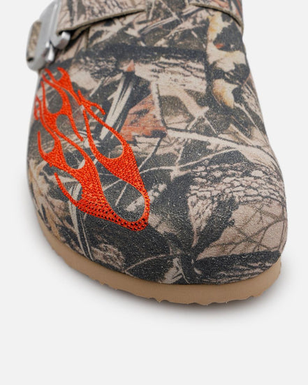 Camouflage-patterned shoe with orange flame design on a white background