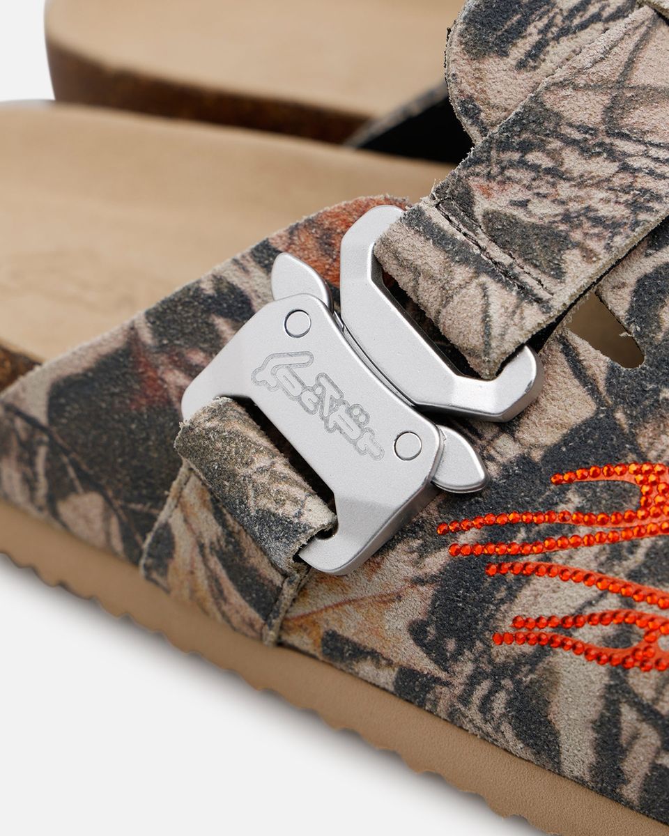 Camouflage sandal with a metal buckle and orange laces on a white background