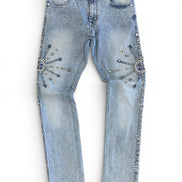 Light blue jeans with decorative embellishments on a white background