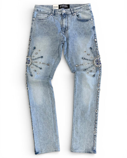 Light blue jeans with decorative embellishments on a white background