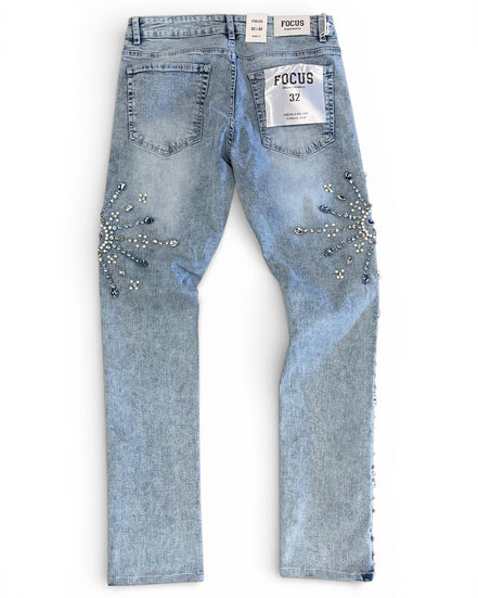 Light blue jeans with rhinestone embellishments on a white background