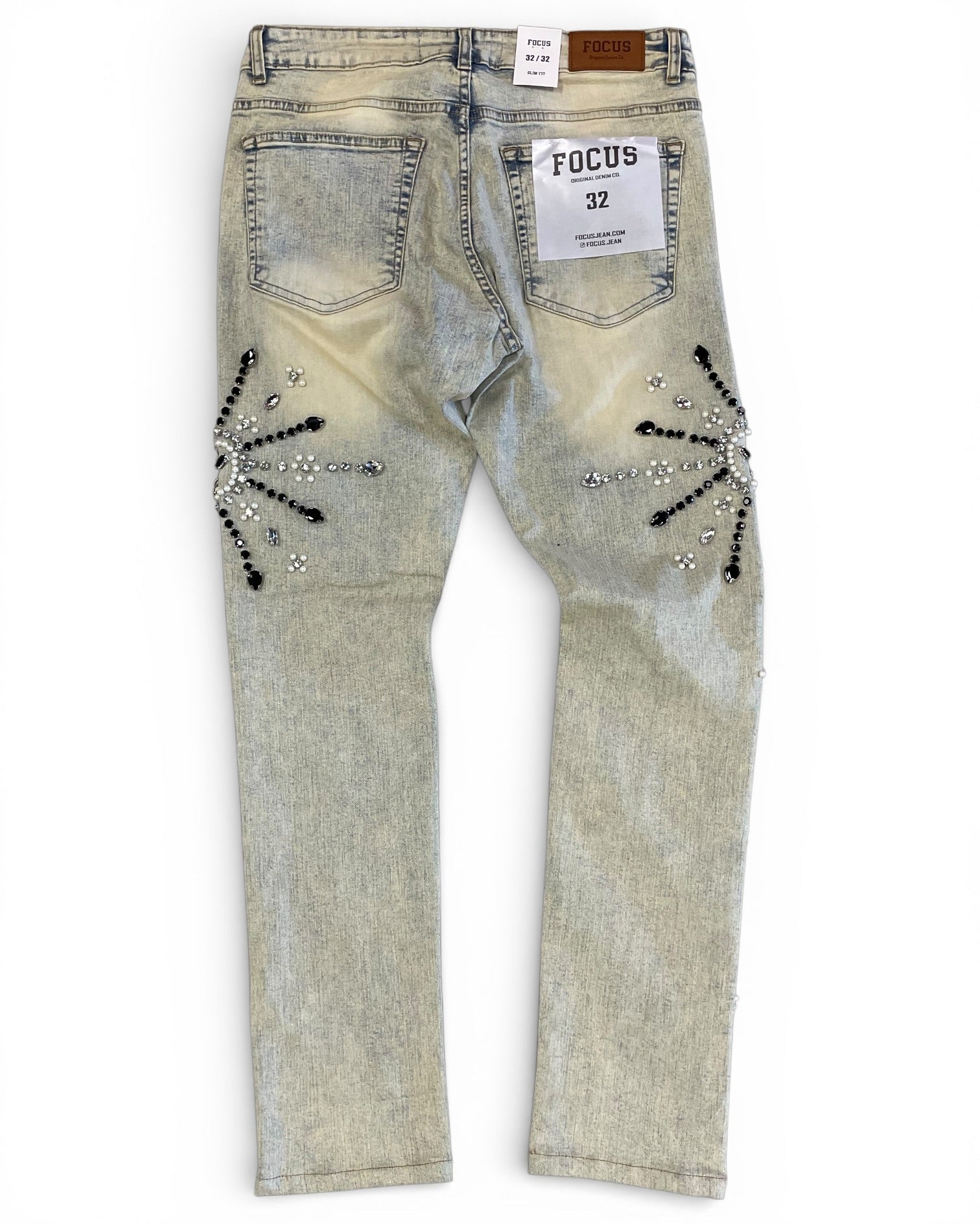 Light-colored jeans with decorative elements on a white background