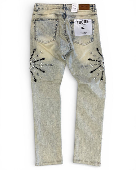 Light-colored jeans with decorative elements on a white background