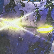 Close-up of a futuristic helmet with glowing yellow visor and intricate design.