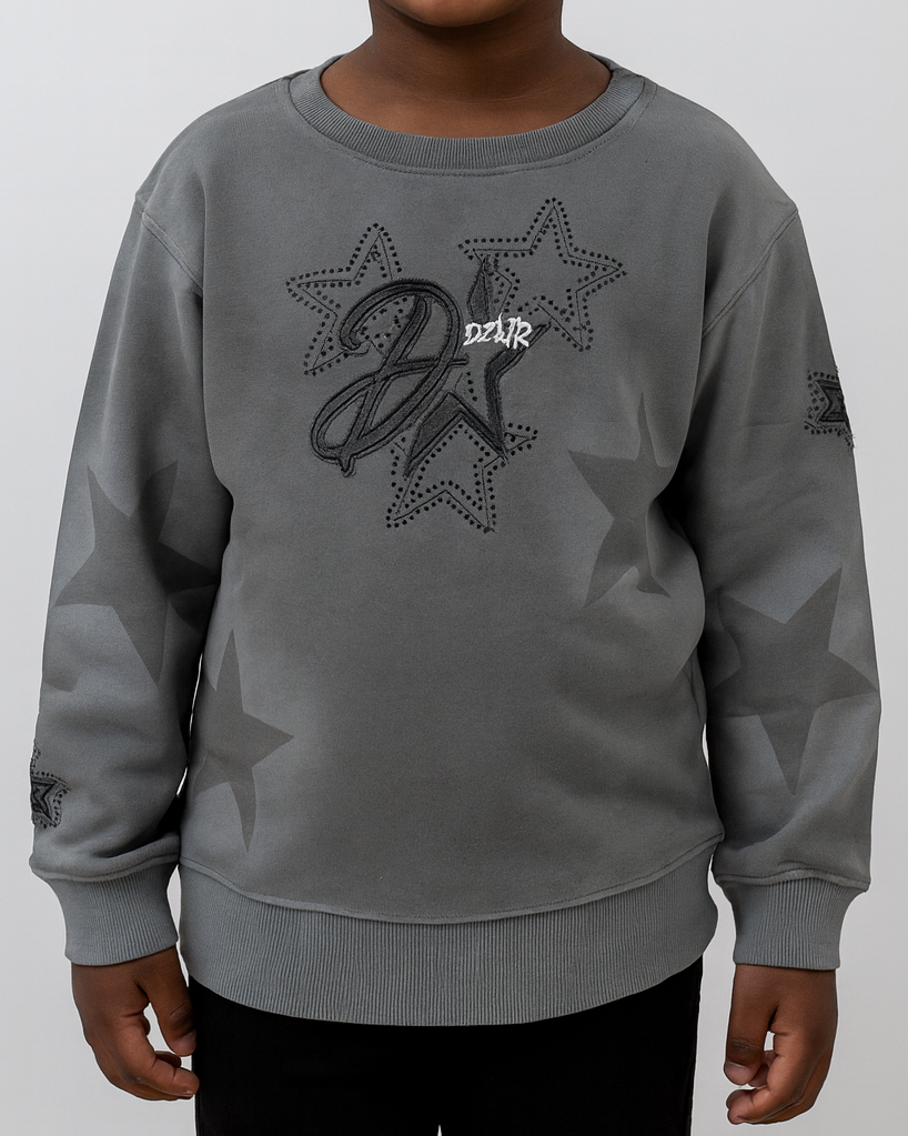 Gray sweatshirt with star design and text on a plain background