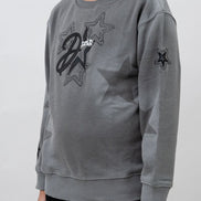 Gray sweatshirt with star designs on a plain background