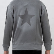 Gray sweatshirt with a star design on the back worn by a person against a white background