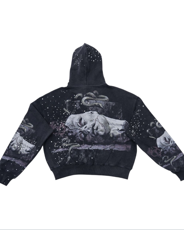 Black hoodie with artistic designs on a white background
