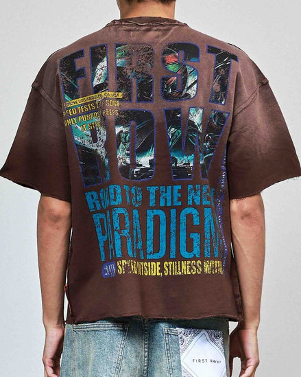Person wearing a brown t-shirt with colorful text on the back, standing against a plain background.