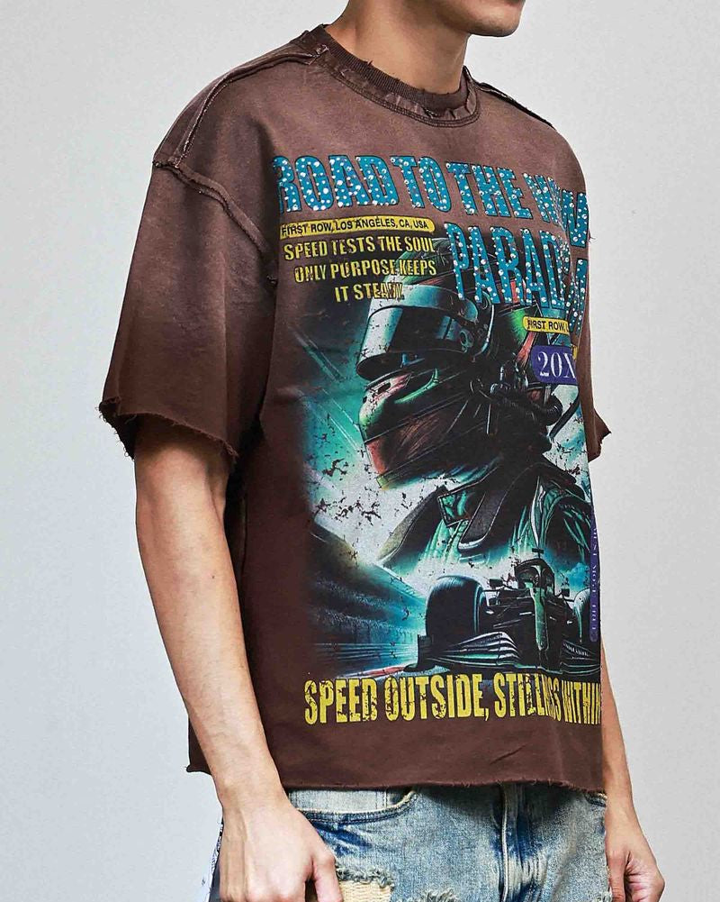 Person wearing a graphic t-shirt with a motorcycle design and text on a plain background