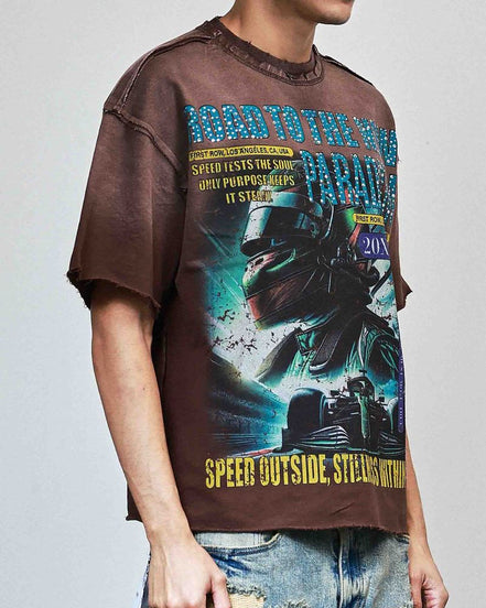 Person wearing a graphic t-shirt with a motorcycle design and text on a plain background