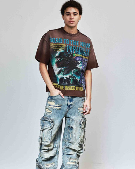 Person wearing a graphic t-shirt and distressed jeans against a plain background