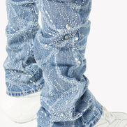 Blue jeans with rhinestone embellishments worn with white sneakers on a white background