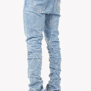Light blue jeans with rhinestone embellishments on a white background