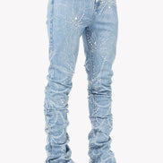 Light blue distressed jeans worn with white sneakers on a white background