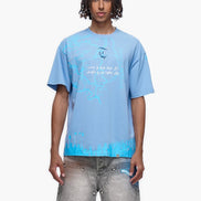 Person wearing a light blue t-shirt with text and graphics on a white background