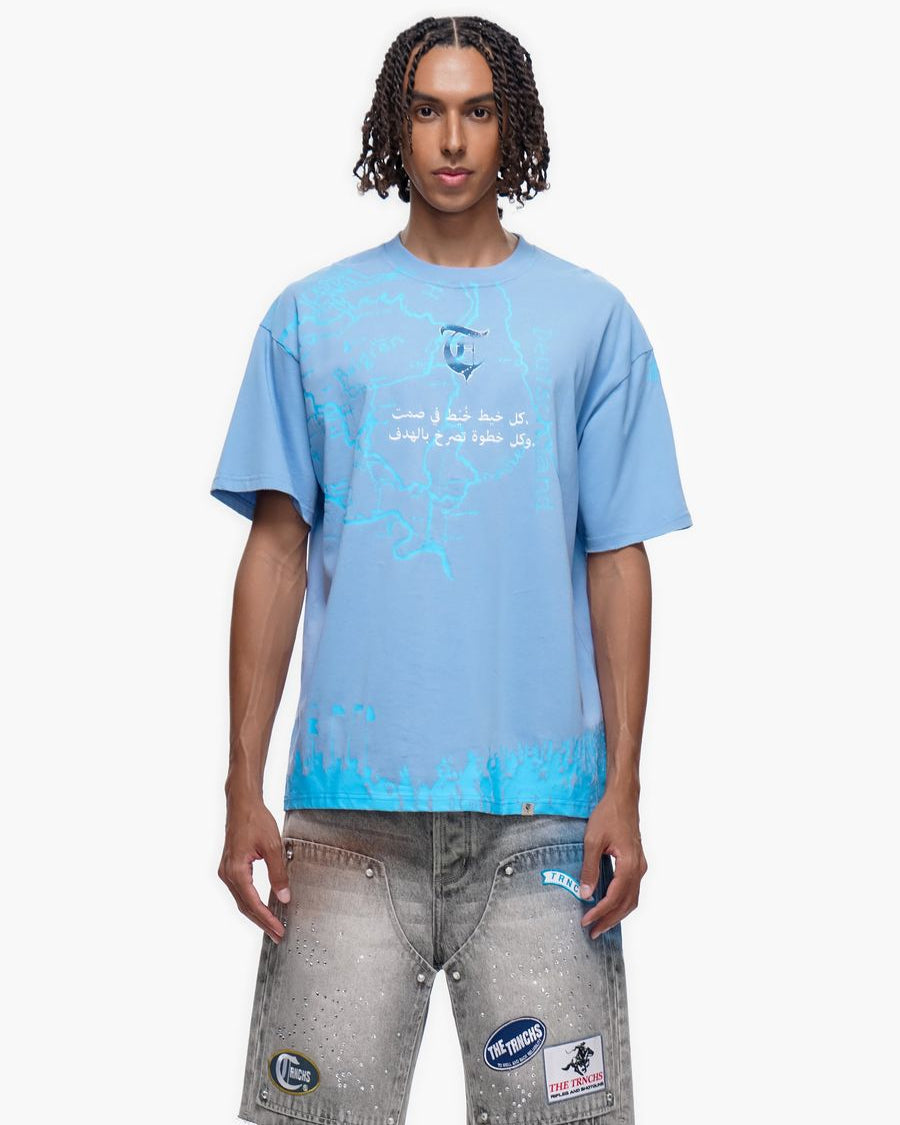 Person wearing a light blue t-shirt with text and graphics on a white background