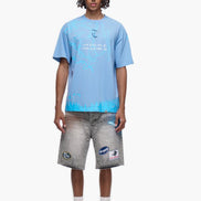 Person wearing a light blue t-shirt and gray shorts on a white background