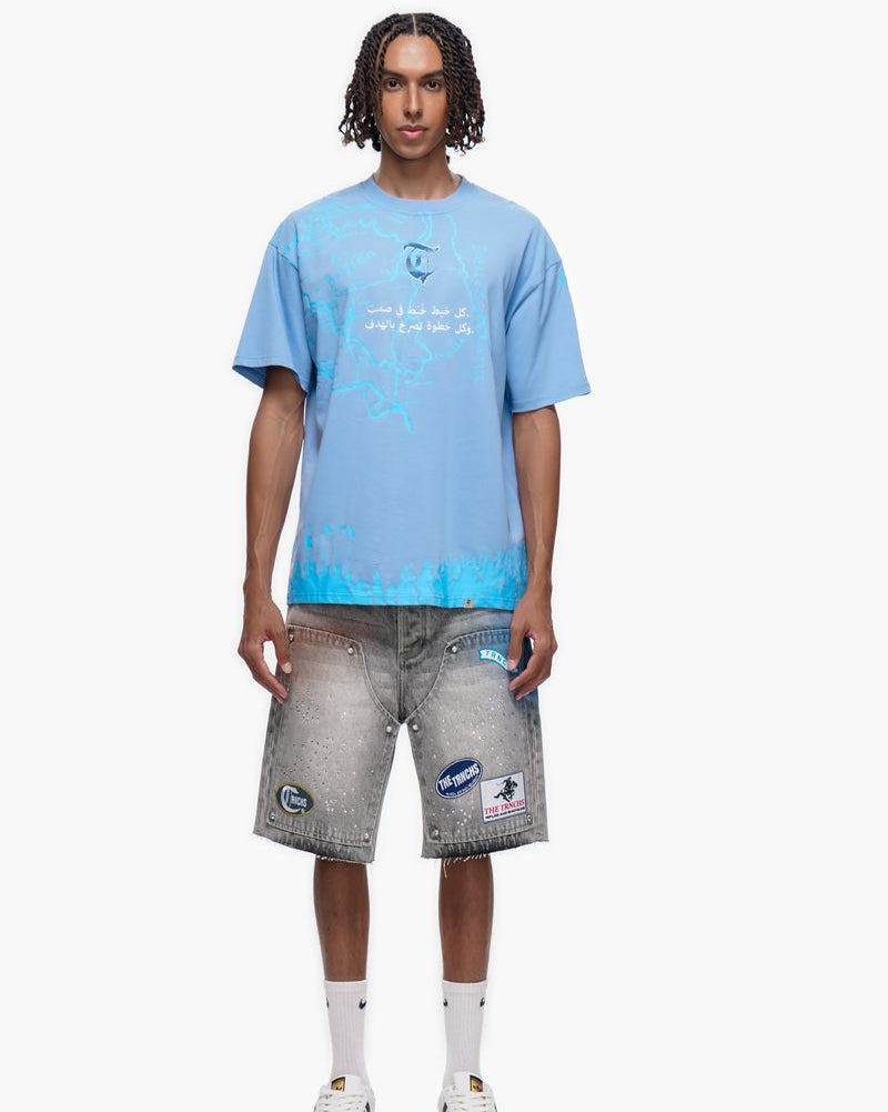 Person wearing a light blue t-shirt and gray shorts on a white background