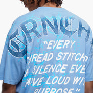 Person wearing a blue t-shirt with text and graphics on the back