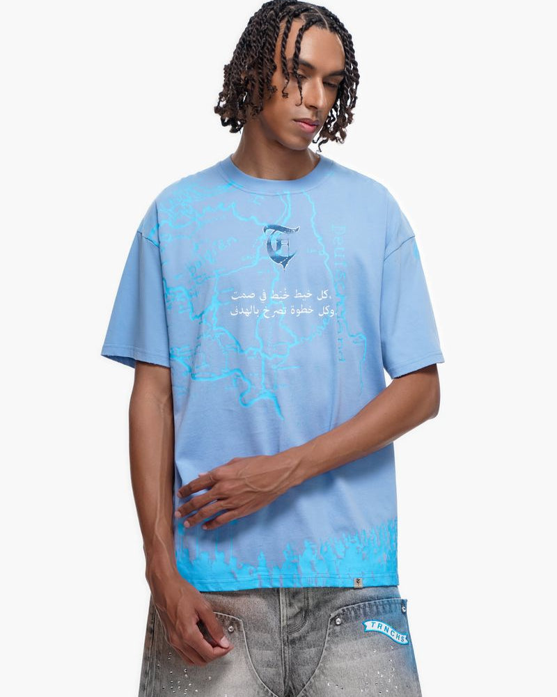 Person wearing a light blue t-shirt with text and graphics on a white background