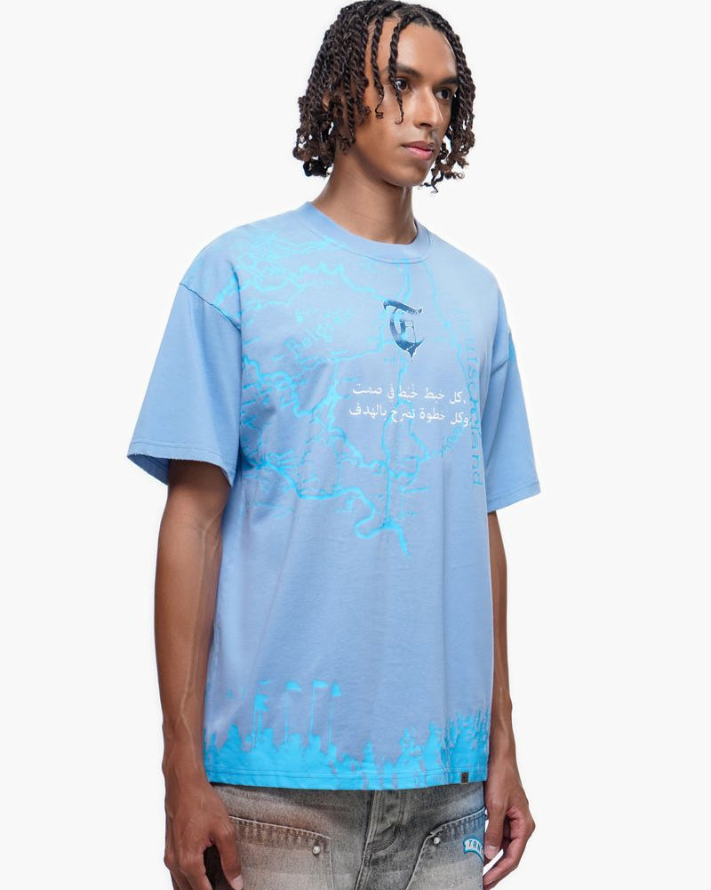 Person wearing a light blue t-shirt with text and graphics on a white background
