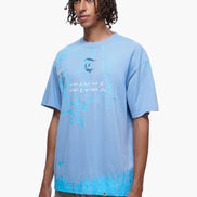 Person wearing a light blue t-shirt with text and graphics on a white background