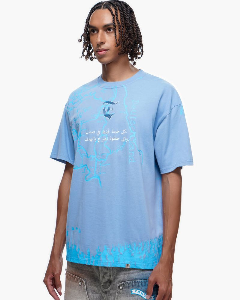 Person wearing a light blue t-shirt with text and graphics on a white background