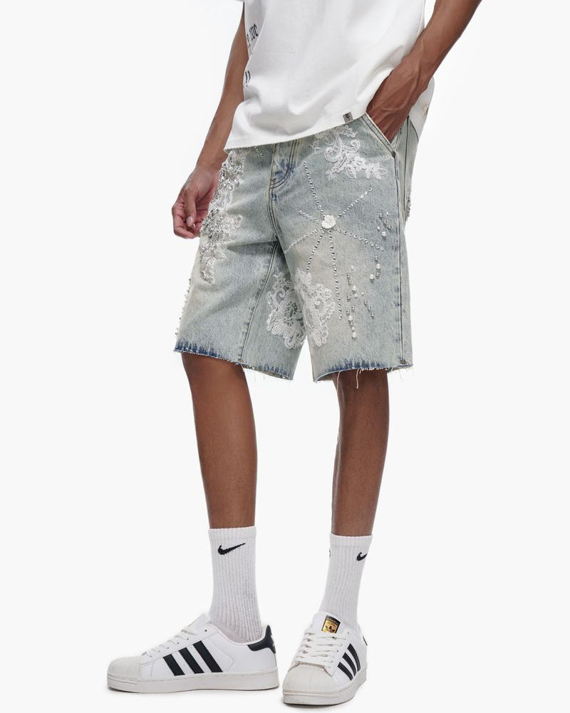 Person wearing light gray shorts with floral patterns, white t-shirt, and Adidas shoes on a white background