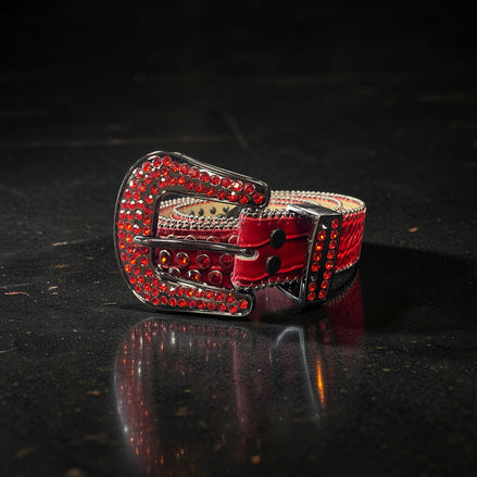 Red belt with decorative buckle on a dark surface