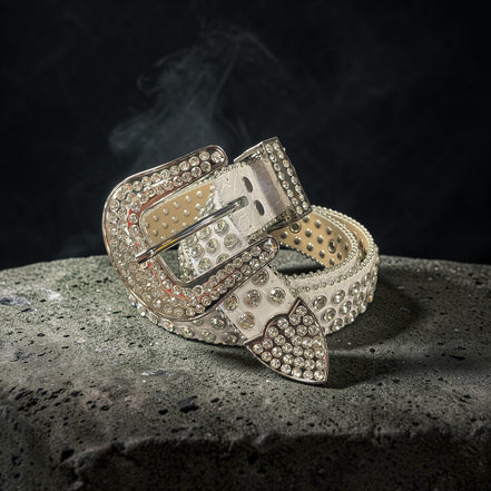 Decorative belt with rhinestone buckle on a textured surface