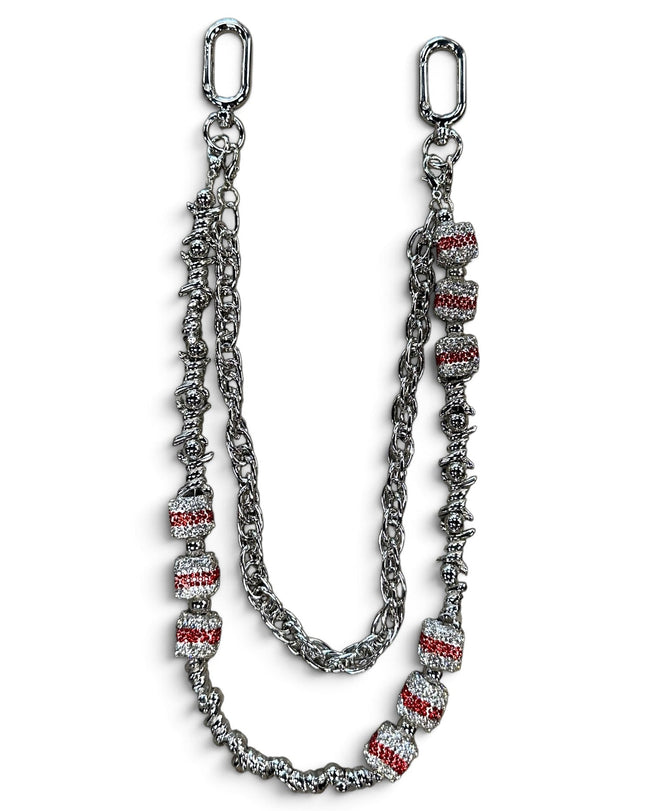 A silver-toned chain accessory with textured links and multiple cylindrical beads set with clear stones and red inlay, displayed on a white background.