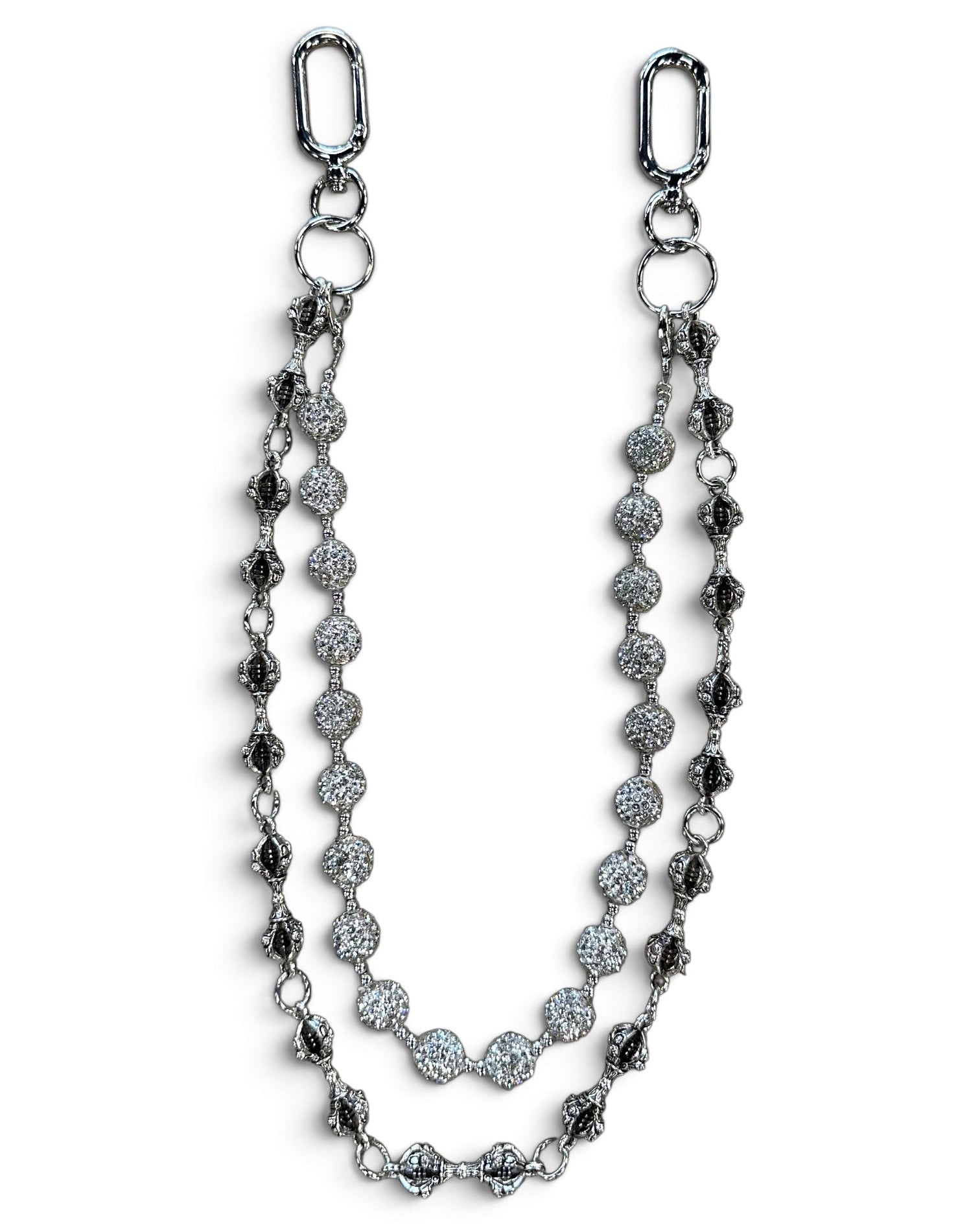A silver-toned double-strand chain accessory featuring textured oval links, round pavé-style discs, and elongated drop links, displayed on a clean white background.