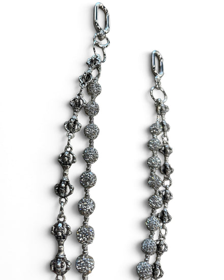 A close-up of a silver-toned beaded chain accessory with textured round beads and lobster clasp ends, shown on a plain white background.
