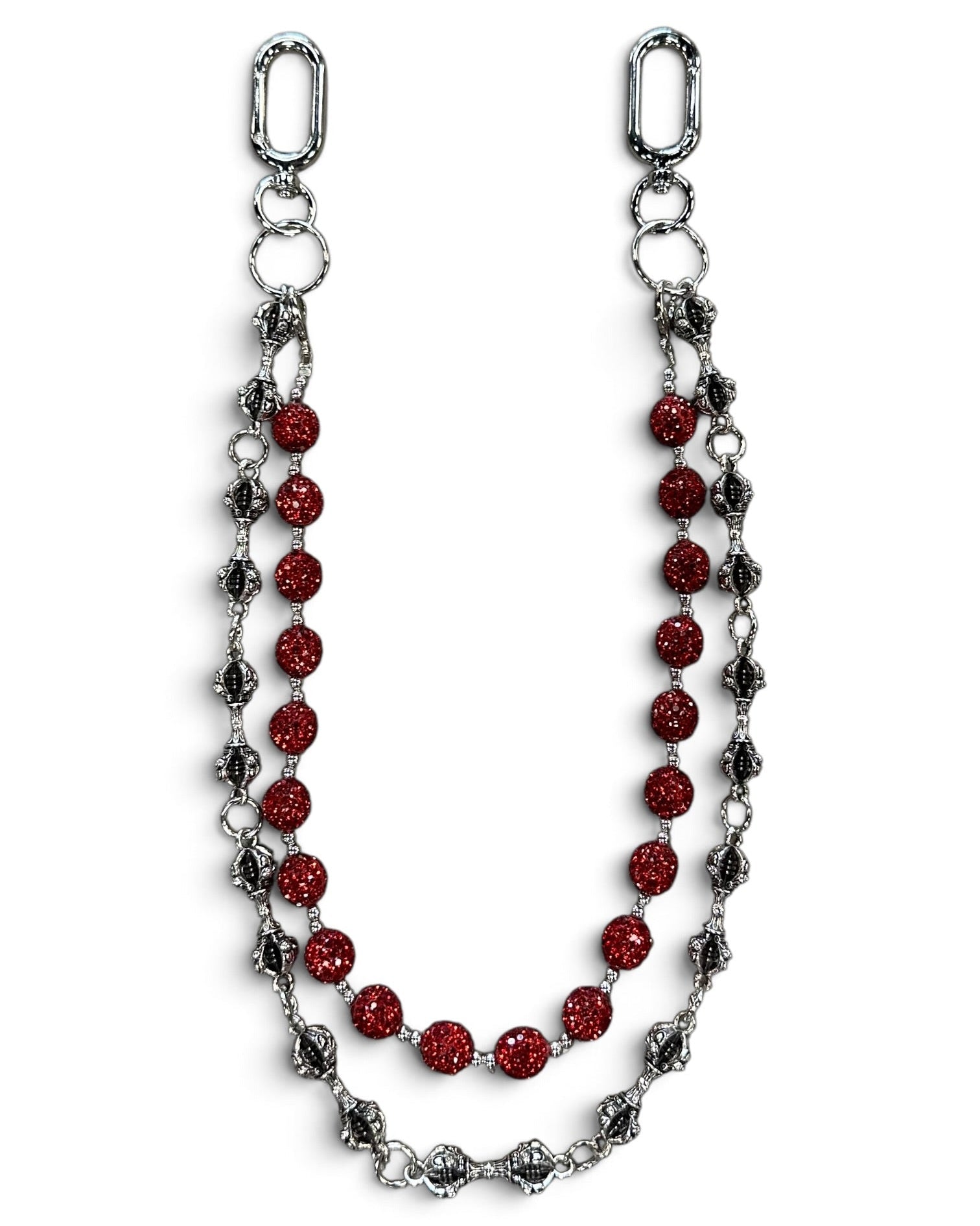 A silver-toned chain accessory featuring a central strand of faceted red beads and flanking strands of textured silver and dark metallic links, displayed on a clean white background.