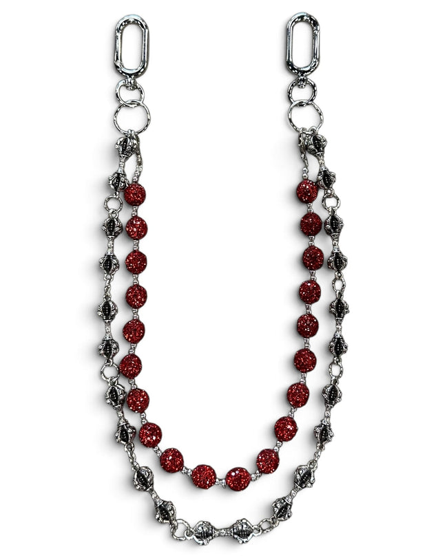 A silver-toned chain accessory featuring a central strand of faceted red beads and flanking strands of textured silver and dark metallic links, displayed on a clean white background.