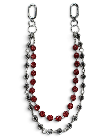A silver-toned chain accessory featuring a central strand of faceted red beads and flanking strands of textured silver and dark metallic links, displayed on a clean white background.