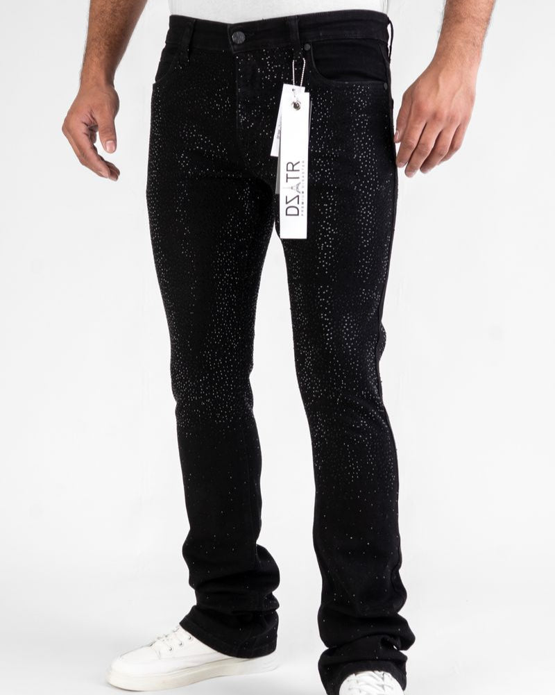 Person wearing black jeans with a brand tag on a white background