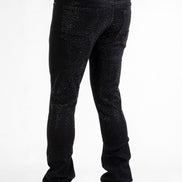 Black jeans with rhinestone embellishments on a white background